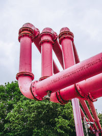 Low angle view of pink pipe against sky