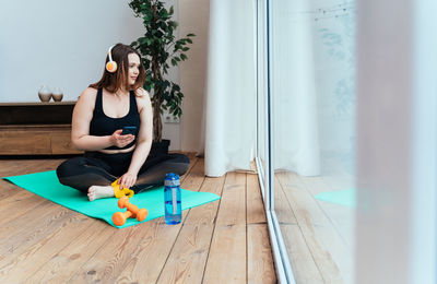 Woman sitting on chair at home