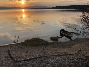 Scenic view of lake against sky during sunset