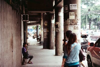 Rear view of women walking in city
