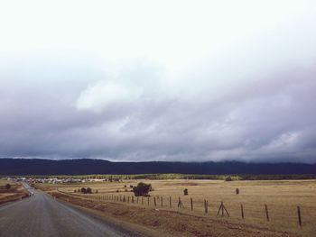 Scenic view of landscape against cloudy sky