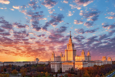 Buildings against cloudy sky during sunset