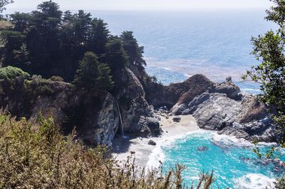 High angle view of rocks by sea against sky