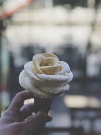 Close-up of hand holding ice cream cone