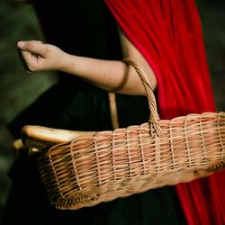 Midsection of woman playing with basket