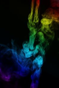 Close-up of illuminated lighting equipment against black background