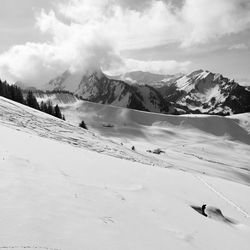 Scenic view of snow covered mountains against sky