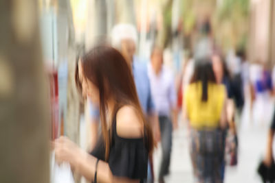 Blurred motion of women standing in city
