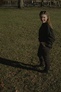 Portrait of boy standing on field