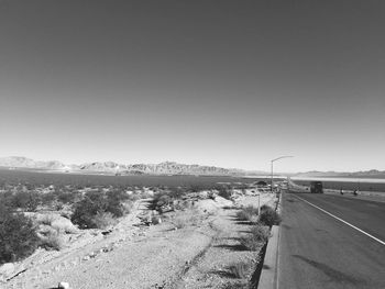Road by landscape against clear sky