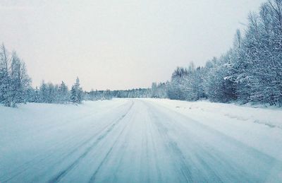 Snow covered landscape against sky