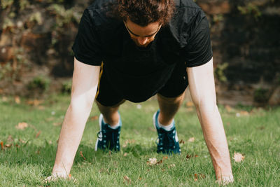 Full length of young man standing on field