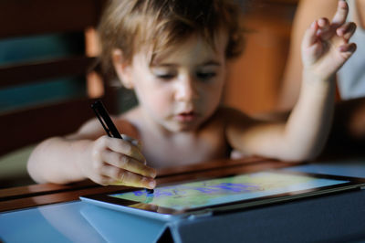 Shirtless girl using digital tablet at home