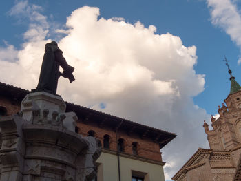 Low angle view of statue against cloudy sky