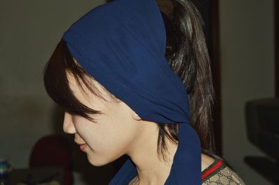 Side view of young woman wearing headscarf