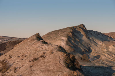 Rock formations on landscape against clear sky