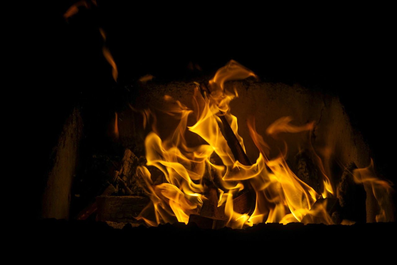 CLOSE-UP OF FIRE ON WOOD AT NIGHT