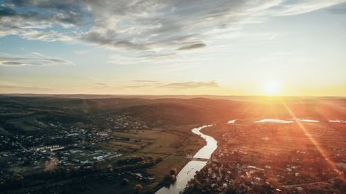 Aerial view of city against sky during sunset