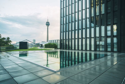 View of modern building against cloudy sky