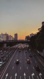 Traffic on road at sunset