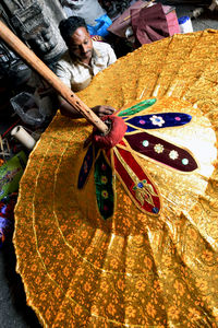 High angle view of woman holding colorful painting