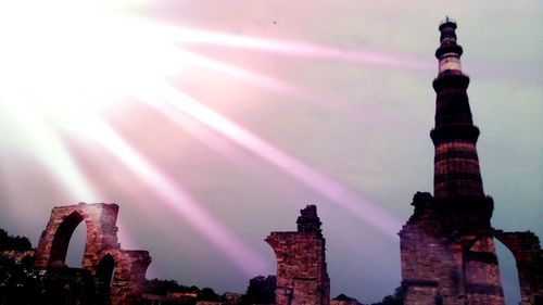 High section of tower against cloudy sky