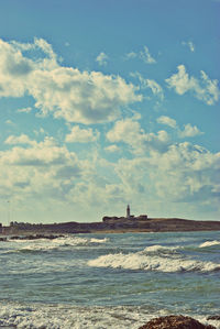 Scenic view of sea against cloudy sky