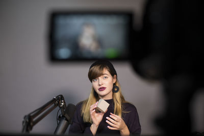 Portrait of young woman using mobile phone