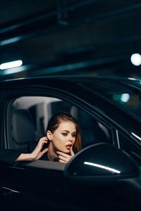 Young woman sitting in car