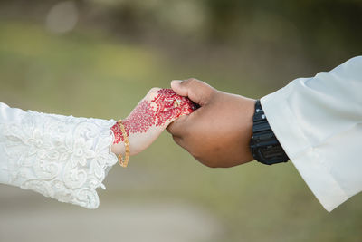 Close-up of hand holding hands