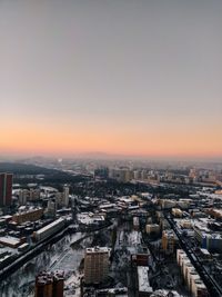 High angle view of buildings against sky during sunset