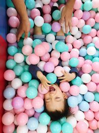 Directly above shot of cute baby boy playing in balls