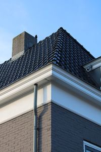 Low angle view of modern building against clear blue sky
