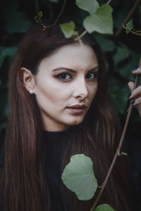 Portrait of young woman with leaves