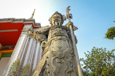 Low angle view of statue against temple building
