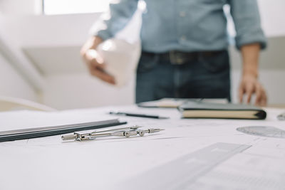 Midsection of man working on table