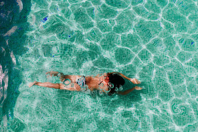 High angle view of woman swimming in pool