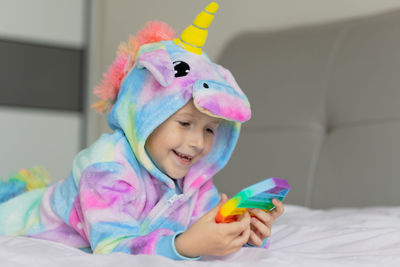 Close-up of cute girl playing with toy at home