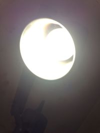 Low angle view of illuminated lamp against sky