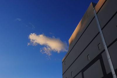 Low angle view of modern building against blue sky