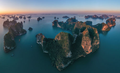 High angle view of rock formation in sea against sky