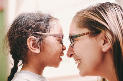 Close-up of mother and daughter embracing at home