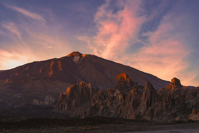 Scenic view of snowcapped mountains against sky during sunset