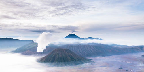 View of volcanic landscape against cloudy sky