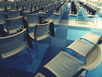 Empty chairs on floor in auditorium