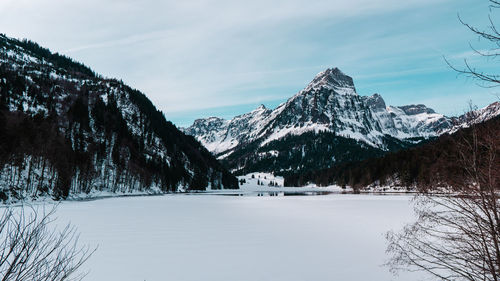 Scenic view of snowcapped mountains against sky