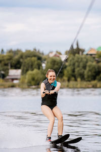 Full length portrait of woman in lake