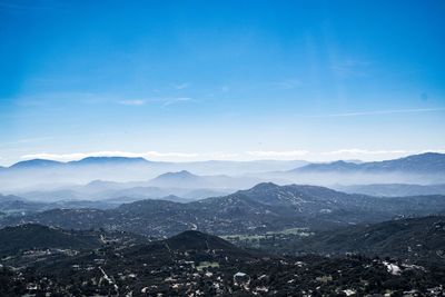 Scenic view of mountains against blue sky