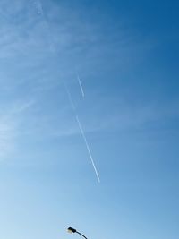 Low angle view of vapor trails in sky