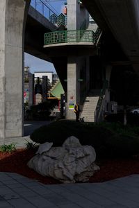 Bridge over street by buildings in city